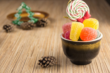 Different sweet candies on rustic wooden table.