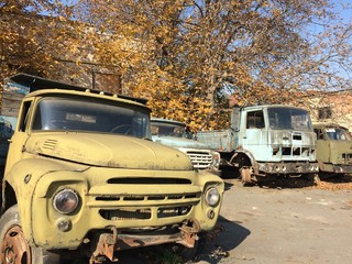Old, abandoned trucks in a landfill.