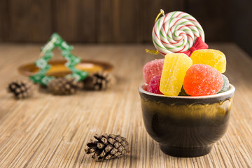 Different sweet candies on rustic wooden table.
