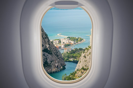 View from airplane window on Omis city in Croatia. Travel and vacation concept.