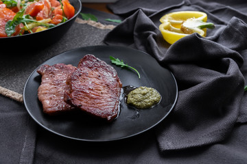 fried meat with vegetable salad and pesto. 