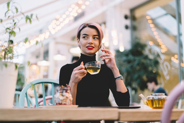 Trendy confident modern woman talking on phone at cafe