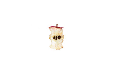 Apple eaten stub with seeds isolated on white background. Healthy vegan food concept. Bitten fresh fruit. Garbage from fruits.