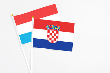Croatia and Luxembourg stick flags on white background. High quality fabric, miniature national...