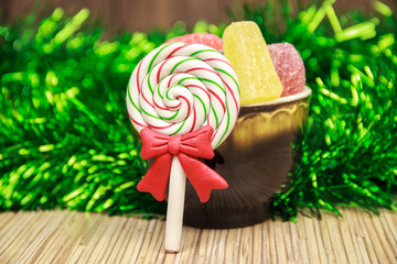 Holiday christmas and new year food stylish decoration.Different sweet candies on rustic wooden table among tinsel.