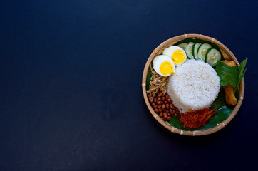 Nasi Lemak is commonly found food in Malaysia, Brunei and Singapore. It is an unofficial national food in Malaysia. Selective focus.