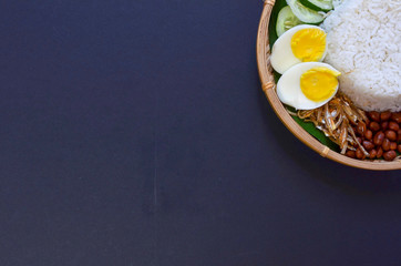 Nasi Lemak is commonly found food in Malaysia, Brunei and Singapore. It is an unofficial national food in Malaysia. Selective focus.