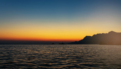 Fototapeta premium orange sunset on the blue sky on the background of the black sea