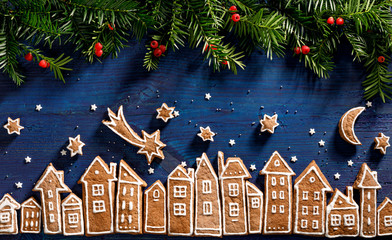Christmas background, image created from gingerbread houses, fresh yew branches and gingerbread...