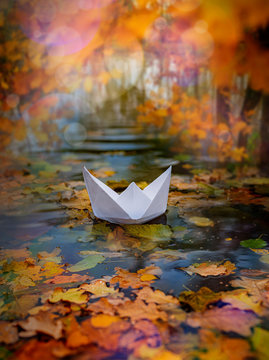 paper boat on an autumn river close up