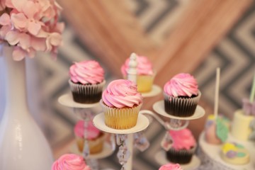 Close up of pink cupcakes on a stand for baby shower