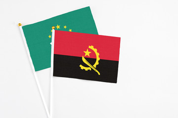 Angola and Macao stick flags on white background. High quality fabric, miniature national flag....