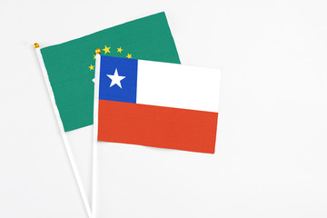 Chile and Macao stick flags on white background. High quality fabric, miniature national flag. Peaceful global concept.White floor for copy space.