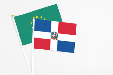 Dominican Republic and Macao stick flags on white background. High quality fabric, miniature national flag. Peaceful global concept.White floor for copy space.