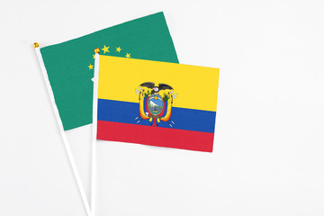 Ecuador and Macao stick flags on white background. High quality fabric, miniature national flag. Peaceful global concept.White floor for copy space.