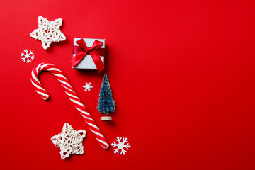 Christmas composition. Candy and decorative stars with snowflakes on red background. Christmas, winter, new year concept. Flat lay, top view, copy space