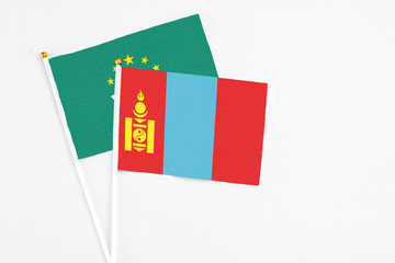 Mongolia and Macao stick flags on white background. High quality fabric, miniature national flag. Peaceful global concept.White floor for copy space.