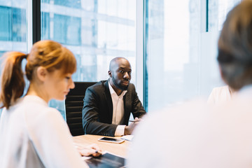 Modern black businessman with colleagues on meeting