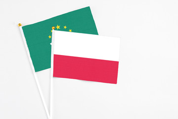 Poland and Macao stick flags on white background. High quality fabric, miniature national flag. Peaceful global concept.White floor for copy space.