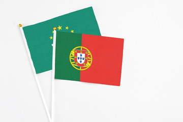 Portugal and Macao stick flags on white background. High quality fabric, miniature national flag. Peaceful global concept.White floor for copy space.