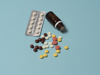 a different of medicines, medicines, pills and vitamins are laid out on a blue background. Health and pharmacy, top view, flatlay