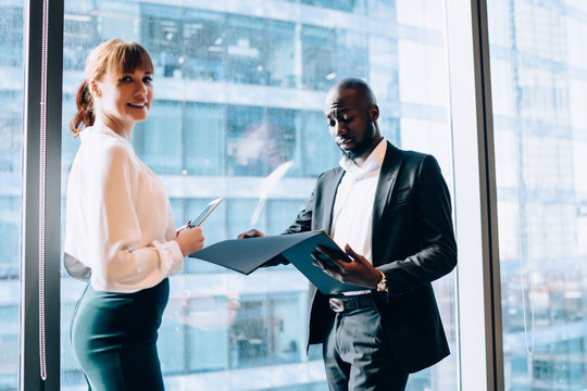 Smiling businesswoman with diverse colleague