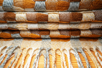 Stacked Knitted Plaid with Fringe. Knitwear Blanket Fabric Texture with a Complex Square Interweaving.