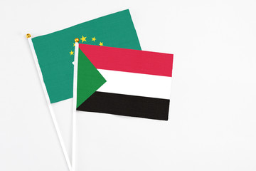 Sudan and Macao stick flags on white background. High quality fabric, miniature national flag. Peaceful global concept.White floor for copy space.