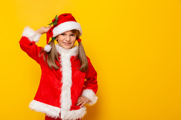 Child in Santa costume holding a mistletoe