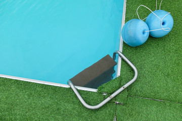 Swimming pool with safety ball and bridge