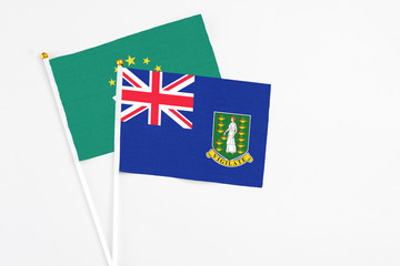Fototapeta premium British Virgin Islands and Macao stick flags on white background. High quality fabric, miniature national flag. Peaceful global concept.White floor for copy space.