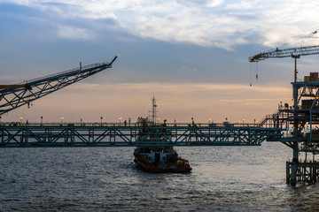 Silhouette of oil production platform at oil field