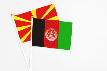 Afghanistan and Macedonia stick flags on white background. High quality fabric, miniature national...