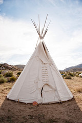 Traditional ceremonial white native american teepee in the desert. 