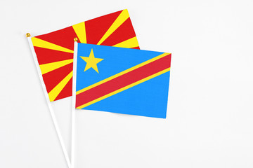 Congo and Macedonia stick flags on white background. High quality fabric, miniature national flag. Peaceful global concept.White floor for copy space.