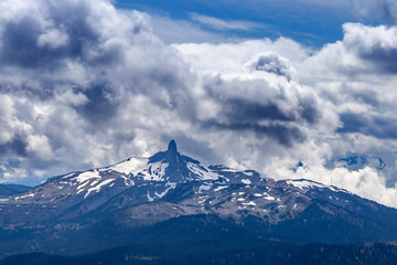 Fototapeta na wymiar Clouds roll by the tall peak in the Whistler mountain range