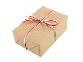 From craft paper, a gift tied with a red and white rope and a bow. Isolate on a white background.