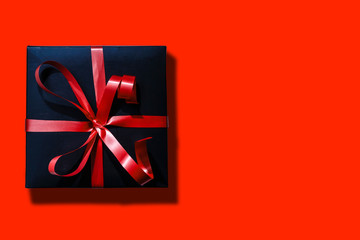 Online shopping of China, 1singles day sale concept. Top view of christmas boxes with red ribbon on red background with copy space