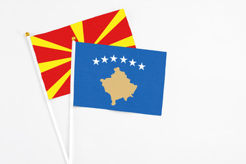 Kosovo and Macedonia stick flags on white background. High quality fabric, miniature national flag. Peaceful global concept.White floor for copy space.