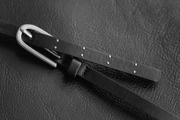 Detail of black leather handbag. Metal buckle strap bag closeup. Texture pattern for background