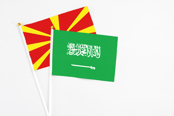 Saudi Arabia and Macedonia stick flags on white background. High quality fabric, miniature national flag. Peaceful global concept.White floor for copy space.