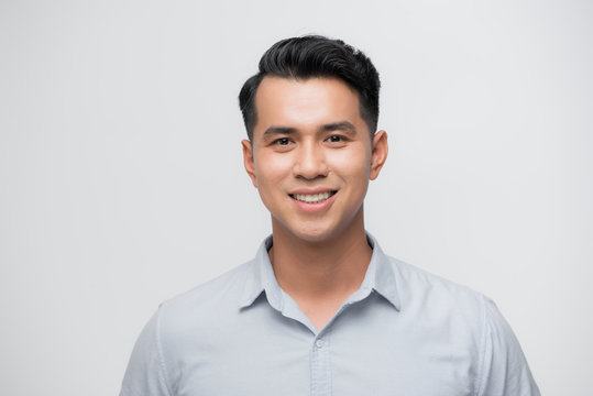 Young good looking asian business man on a white background isolated