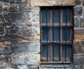 Fototapeta na wymiar old wooden window in stone wall