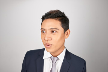 Wow and surprised Asian entrepreneur businessman on white background