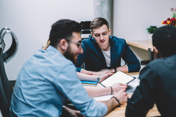 Group of diversity people collaborating near desktop and making research of information about proud ceo and accounting via digital tablet with blank screen area for your internet advertising