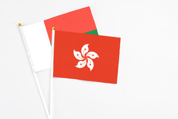 Hong Kong and Madagascar stick flags on white background. High quality fabric, miniature national flag. Peaceful global concept.White floor for copy space.