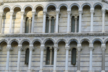 Closeup of the beautiful round arches with their columns at the facade of the Baptistery of St. John, Piazza des Miracoli, Pisa, Italy, Europe