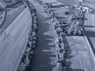 Aerial view of river Arno between cultivated fields
