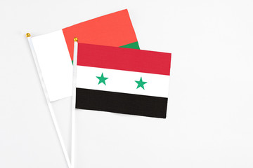 Syria and Madagascar stick flags on white background. High quality fabric, miniature national flag....