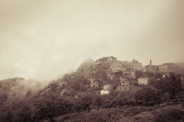 Village of Speloncato in Corsica shrouded in mist
